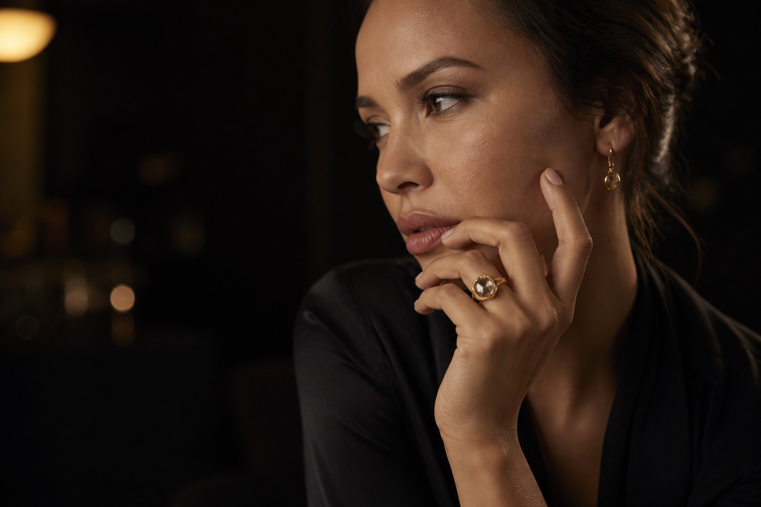 Woman wearing a custom yellow-gold gemstone ring